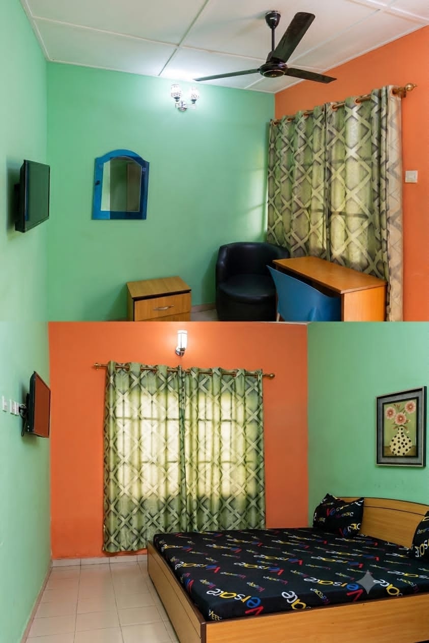 Guest room with seating, television and bed at PIKKMASTER BMV SUITE, 139 IBB Way, Calabar